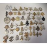 Approx. fifty military cap badges and other insignia, some copies: to include 28th London Regt.;