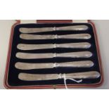 A set of six tea knives, on bead bordered silver handles  Thomas Bradbury & Sons  Sheffield 1896