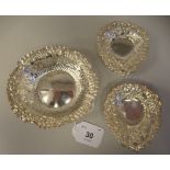 A pair of late Victorian silver heart shape sweet dishes with embossed and pierced decoration, on