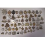 Approx. fifty military cap badges and other insignia, some copies: to include The Honourable