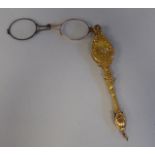 A late 19thC gilt metal mounted lorgnette, decoratively cast with engraved and other ornament and