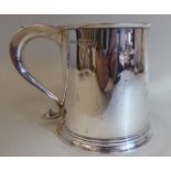 A 19thC style silver mug with an applied wire rim and hollow S-shape handle, on a stepped footrim