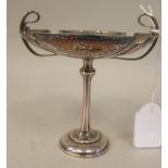 An Art Nouveau silver pedestal sweet dish with opposing looped wire handles, elevated on a slender