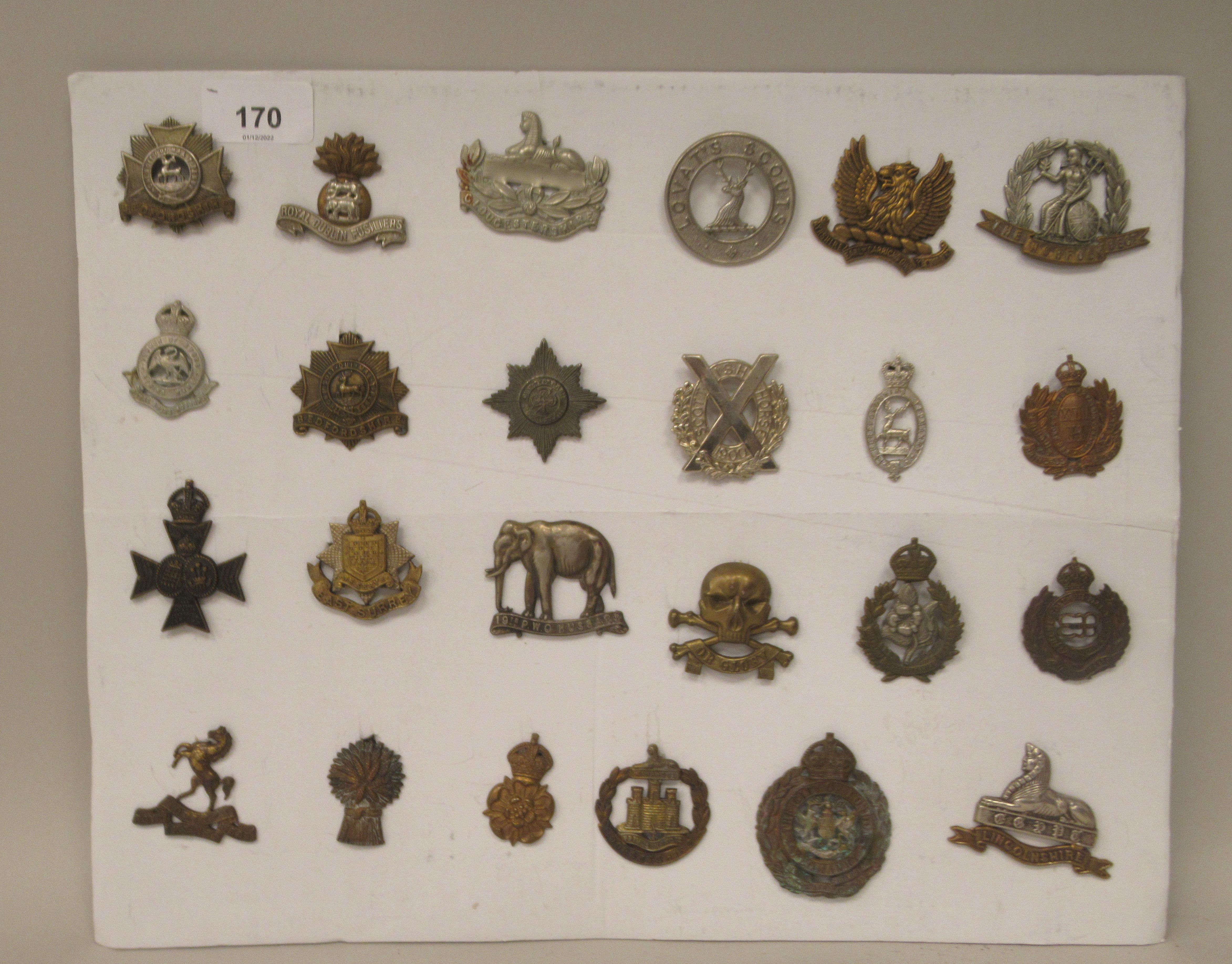 Twenty-two military cap badges and other insignia, some copies: to include East Surrey; Lovat's