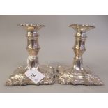 A pair of 18/19thC style loaded silver dwarf candlesticks, each with a detachable sconce and vase