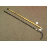 Two vintage swordsticks, one with a lacquered rustic wooden shaft, crook handle and brass ferrule,