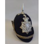 A Black Watch black fabric covered helmet with a chinstrap  bears a Dolan & Co London label  (Please