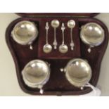 A set of four mid Victorian silver salt cellars of squat, bulbous form with floral engraved and