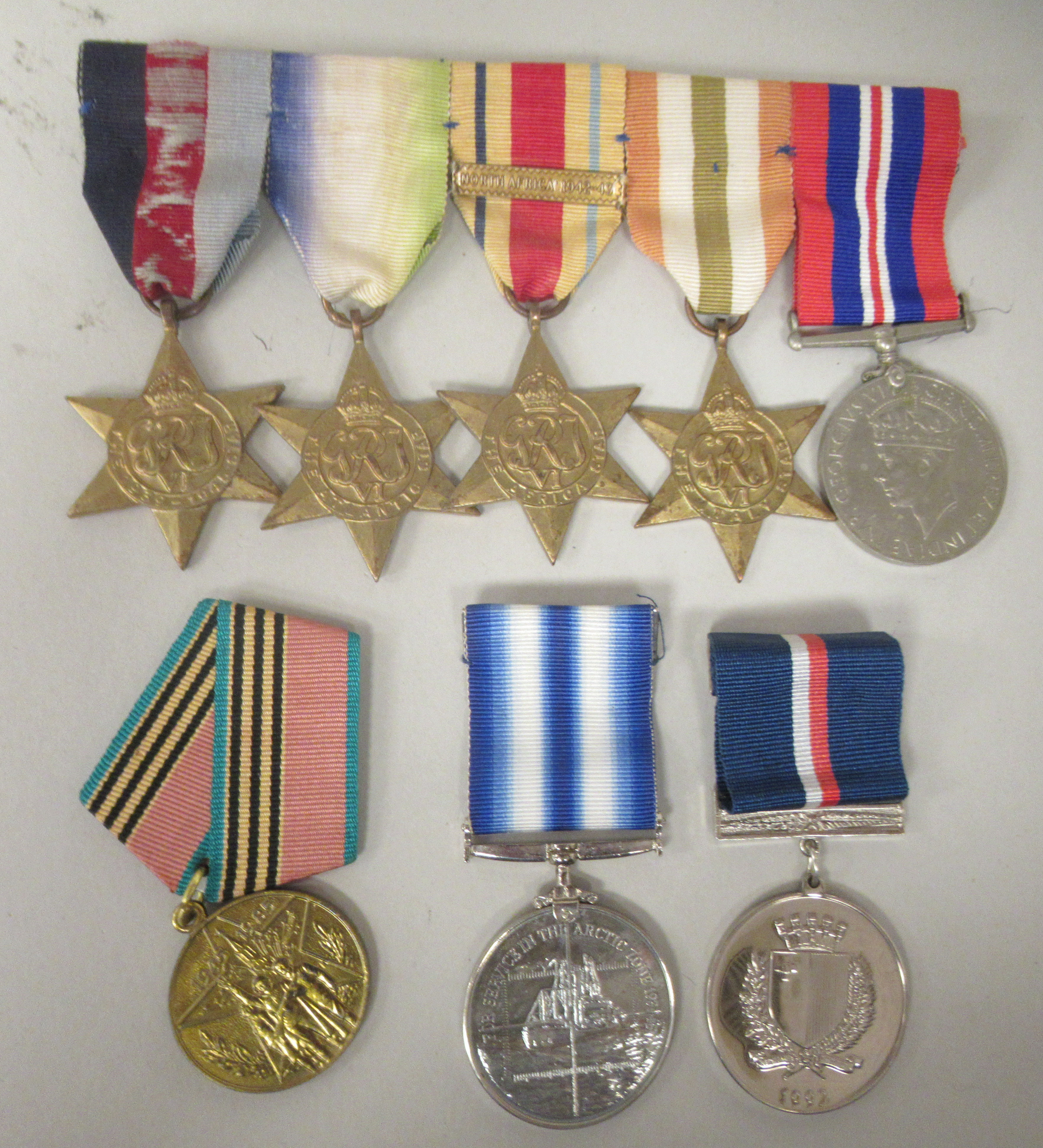 A 1939-1945 British War medal and ribbons; The 1939-1945 Star; The Atlantic Star; The Italy Star;
