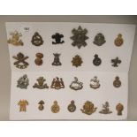 Twenty-five military cap badges and other insignia, some copies: to include The Life Guards;