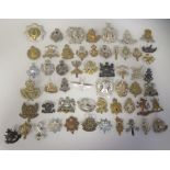 Approx. fifty military cap badges and other insignia, some copies: to include 10 Royal Hussars;