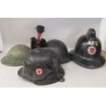 A Kings Own Rifle Corps uniform headdress; a vintage Auxiliary Fire Service black helmet; a green