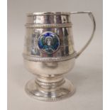 A silver Christening pedestal mug of tapered cylindrical form with an angular handle, an applied