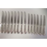 A set of eight silver pistol grip handled table knives with stainless steel blades; and a matching