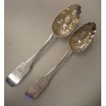 A pair of George IV Irish silver fiddle pattern berry spoons with scratch engraved stems and