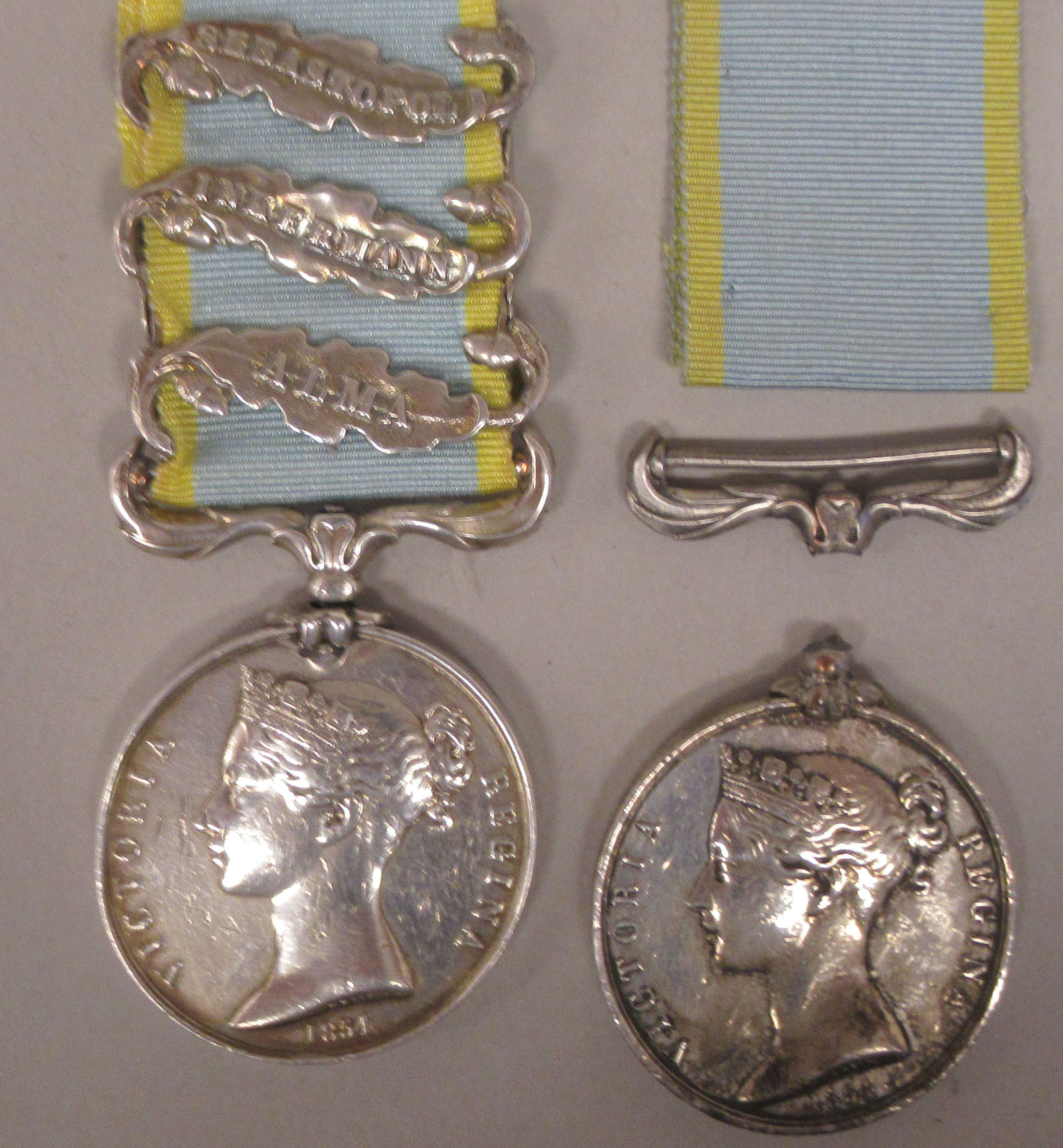 A Crimea medal with Queen Victoria's profile portrait on the obverse and ribbon; three oakleaf