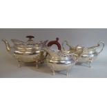 A three piece silver tea set of oval, bulbous form with angled, pierced upstand rims, comprising a