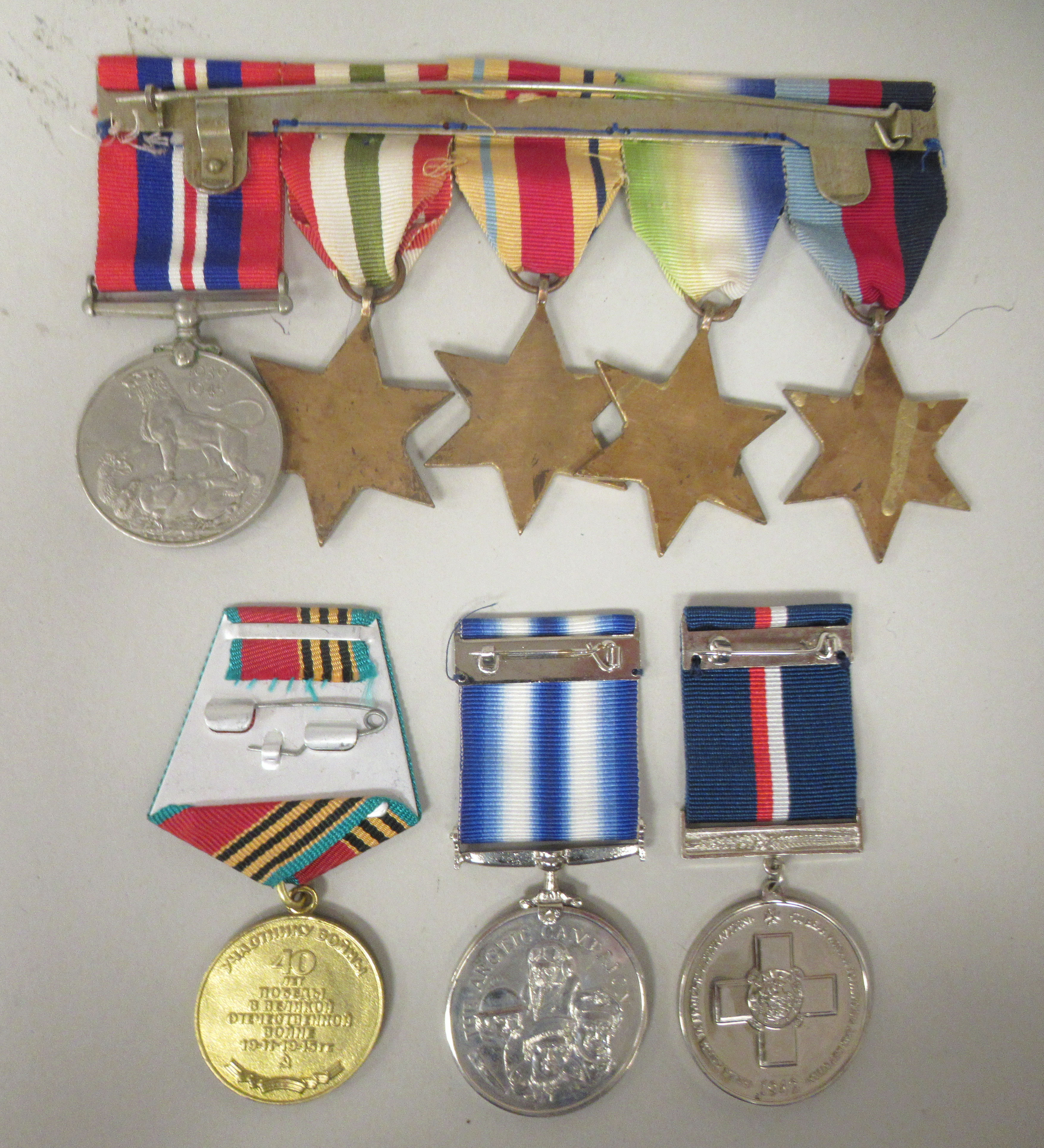 A 1939-1945 British War medal and ribbons; The 1939-1945 Star; The Atlantic Star; The Italy Star; - Image 2 of 2