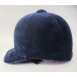 A Christy Beaufort Windsor navy blue velvet covered, flexible peaked riding helmet  size 7.5"