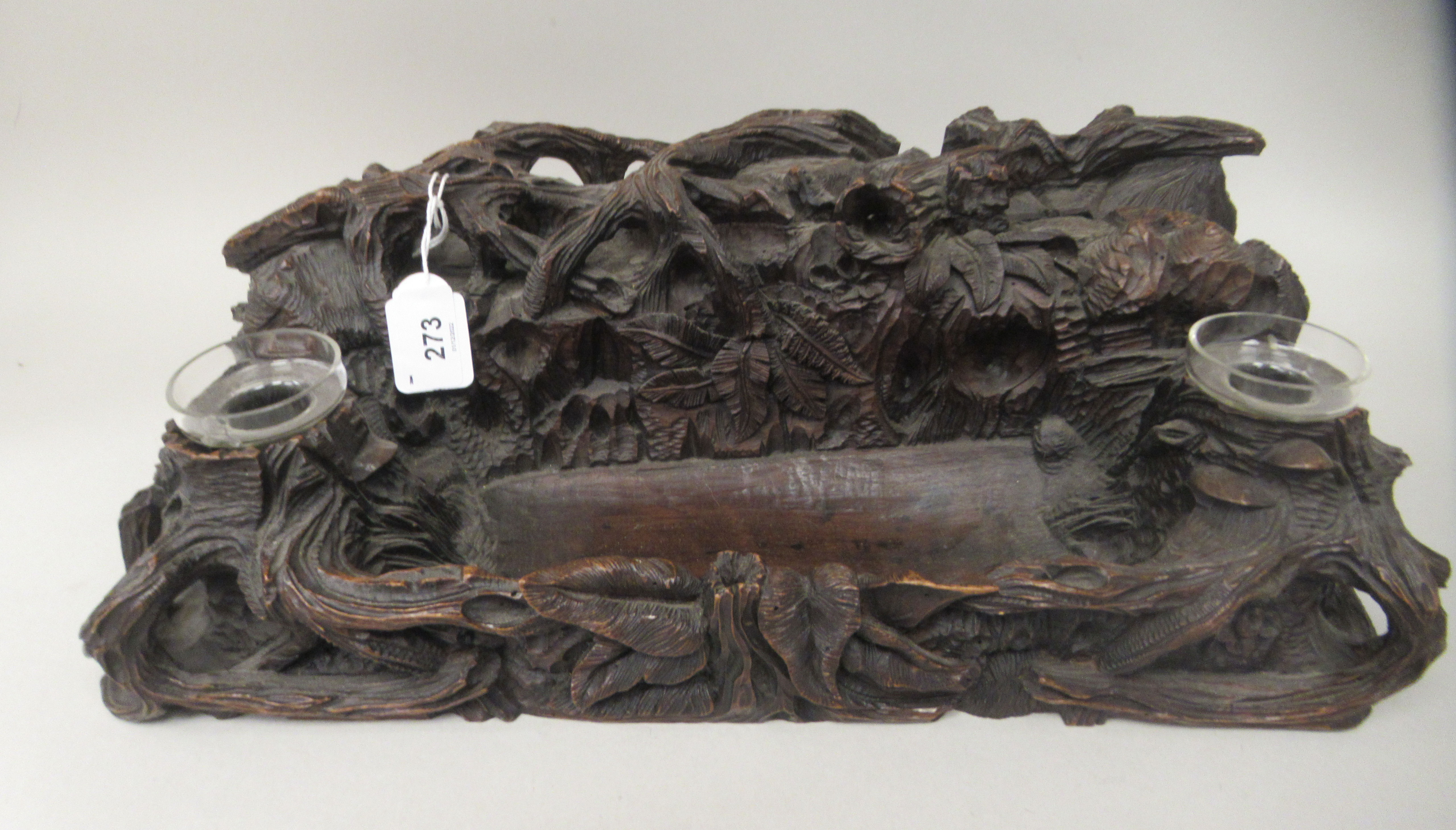 A 19thC Black Forest deskstand, naturalistically carved as a woodland floor, incorporating a pen