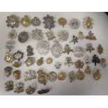 Approx. fifty military cap badges and other insignia, some copies: to include The The Royal Scots