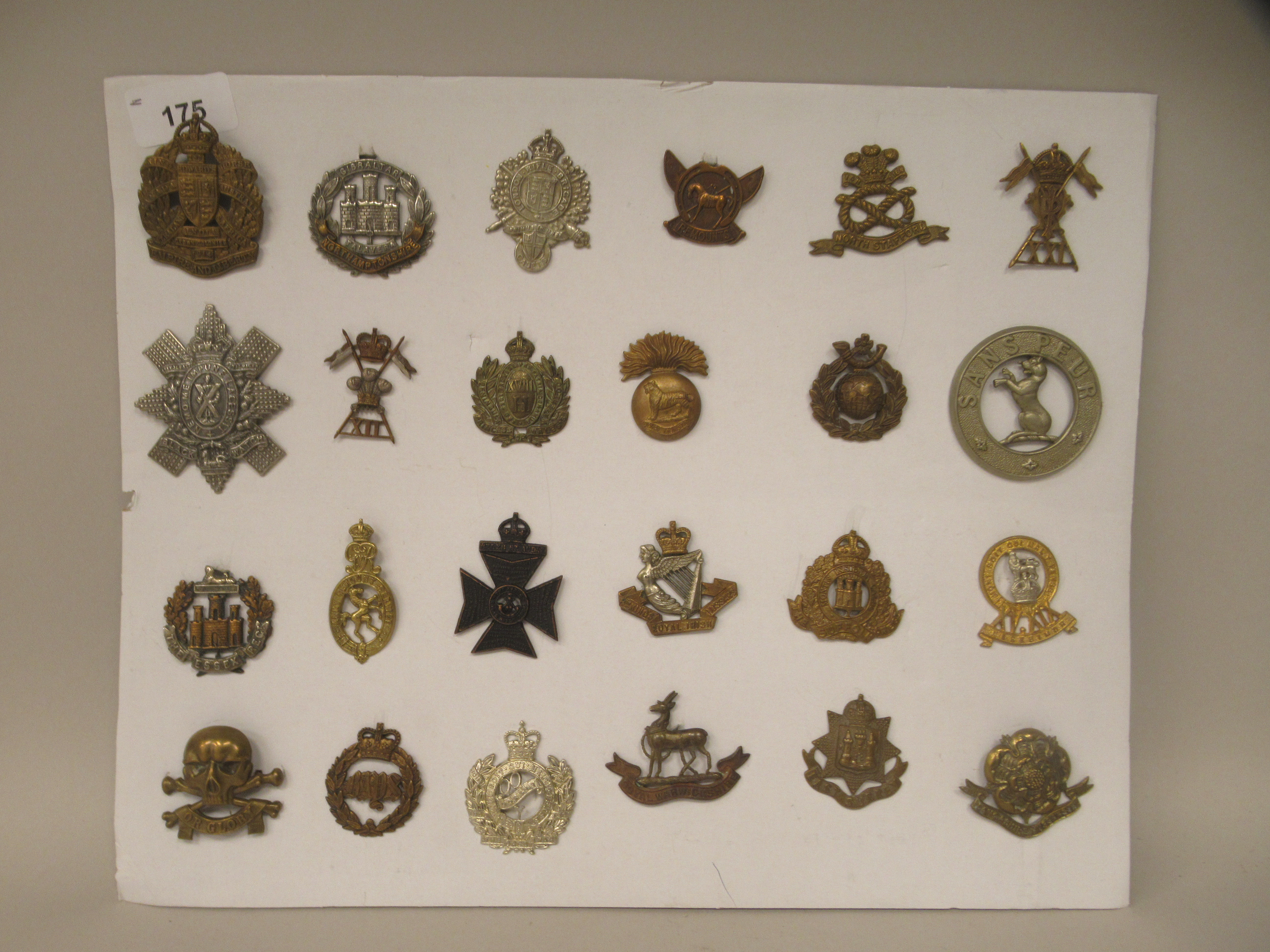 Twenty-four military cap badges and other insignia, some copies: to include The Sussex Regt.; King's