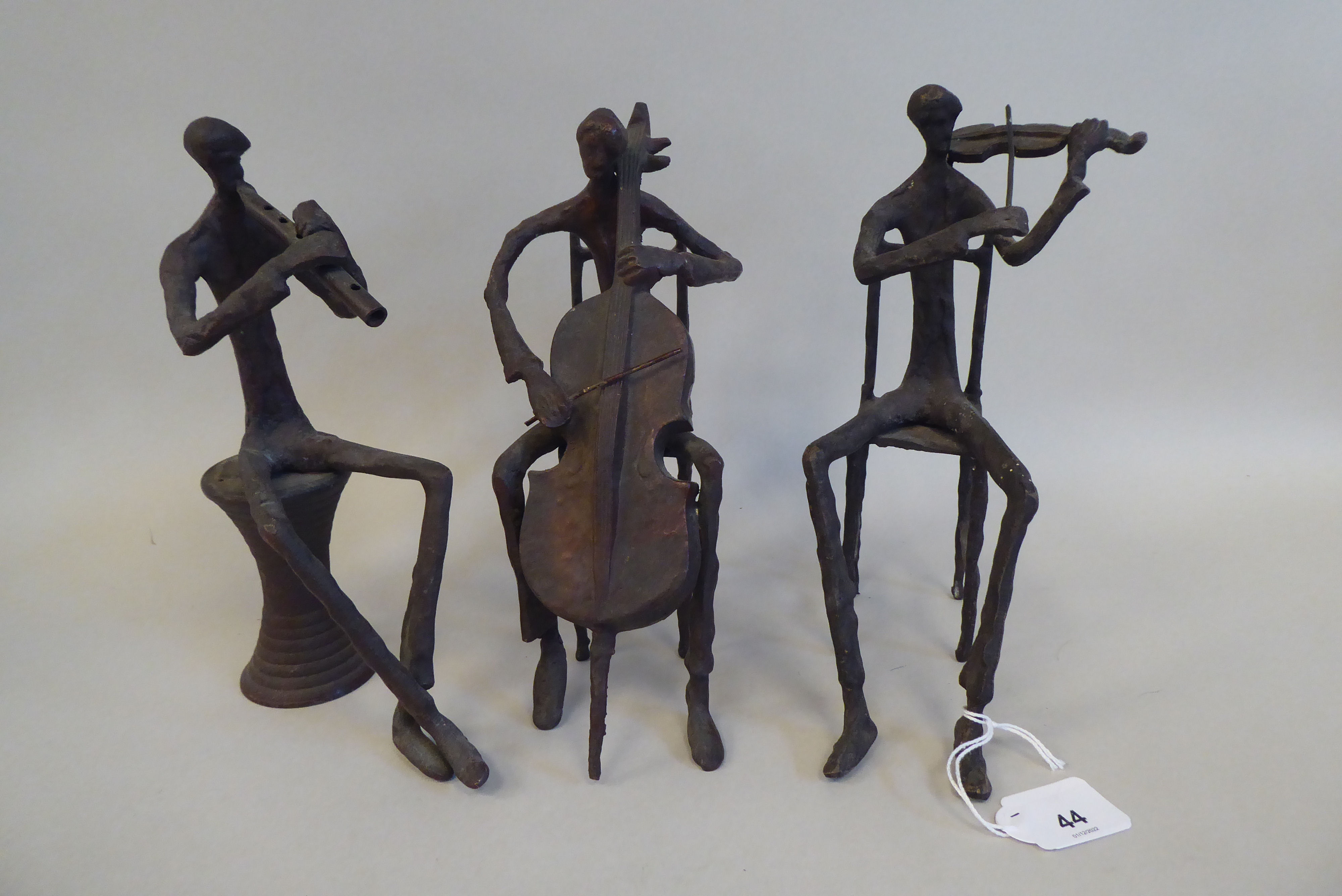 In the manner of Giacometti - a series of three painted bronze sculptures, featuring seated jazz