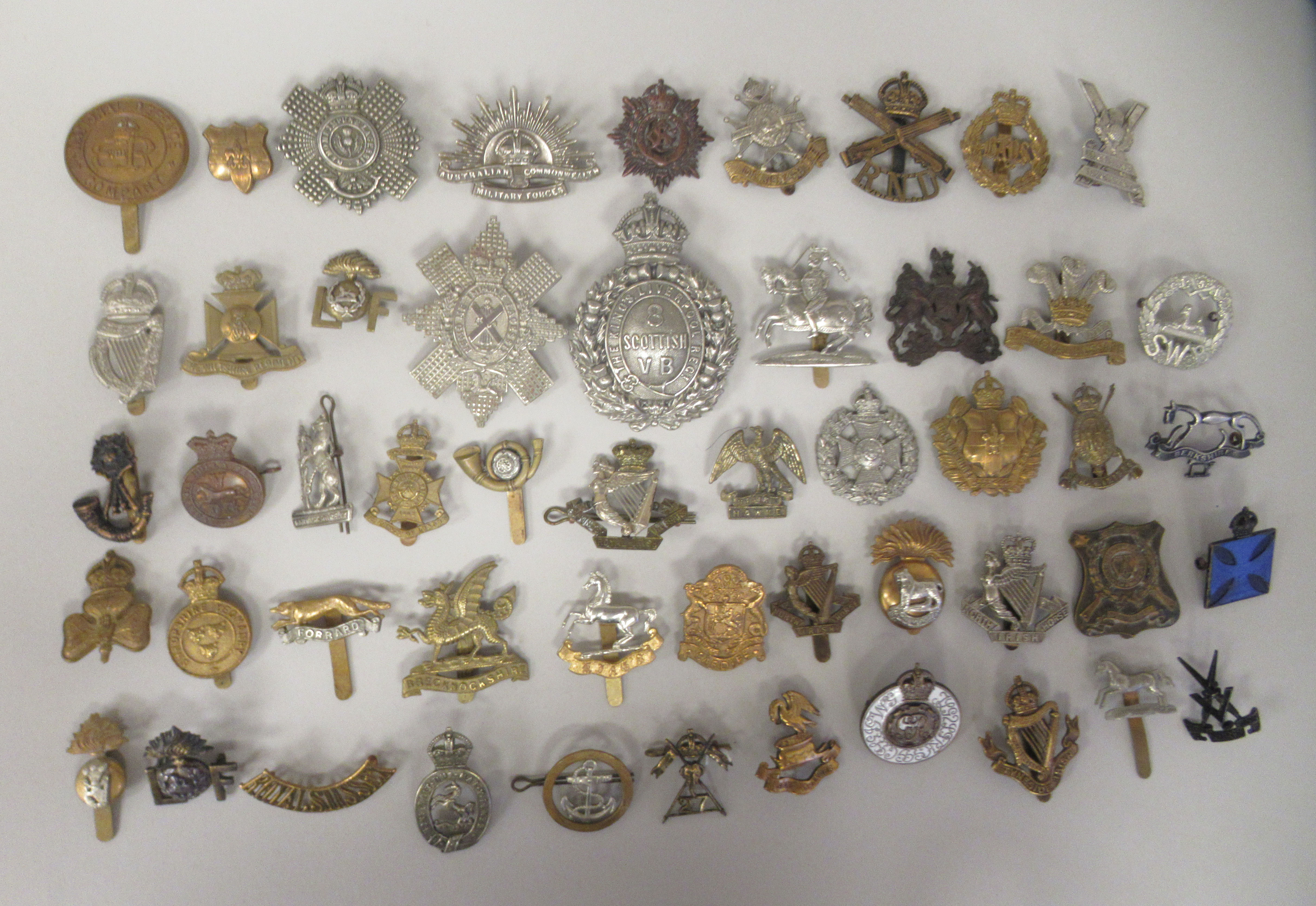 Approx. fifty military cap badges and other insignia, some copies: to include Kings Liverpool Regt.;