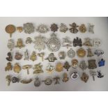 Approx. fifty military cap badges and other insignia, some copies: to include Kings Liverpool Regt.;