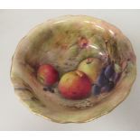 A Royal Worcester china, wavy edged, footed bowl, decorated with apples, grapes, foliage and blossom