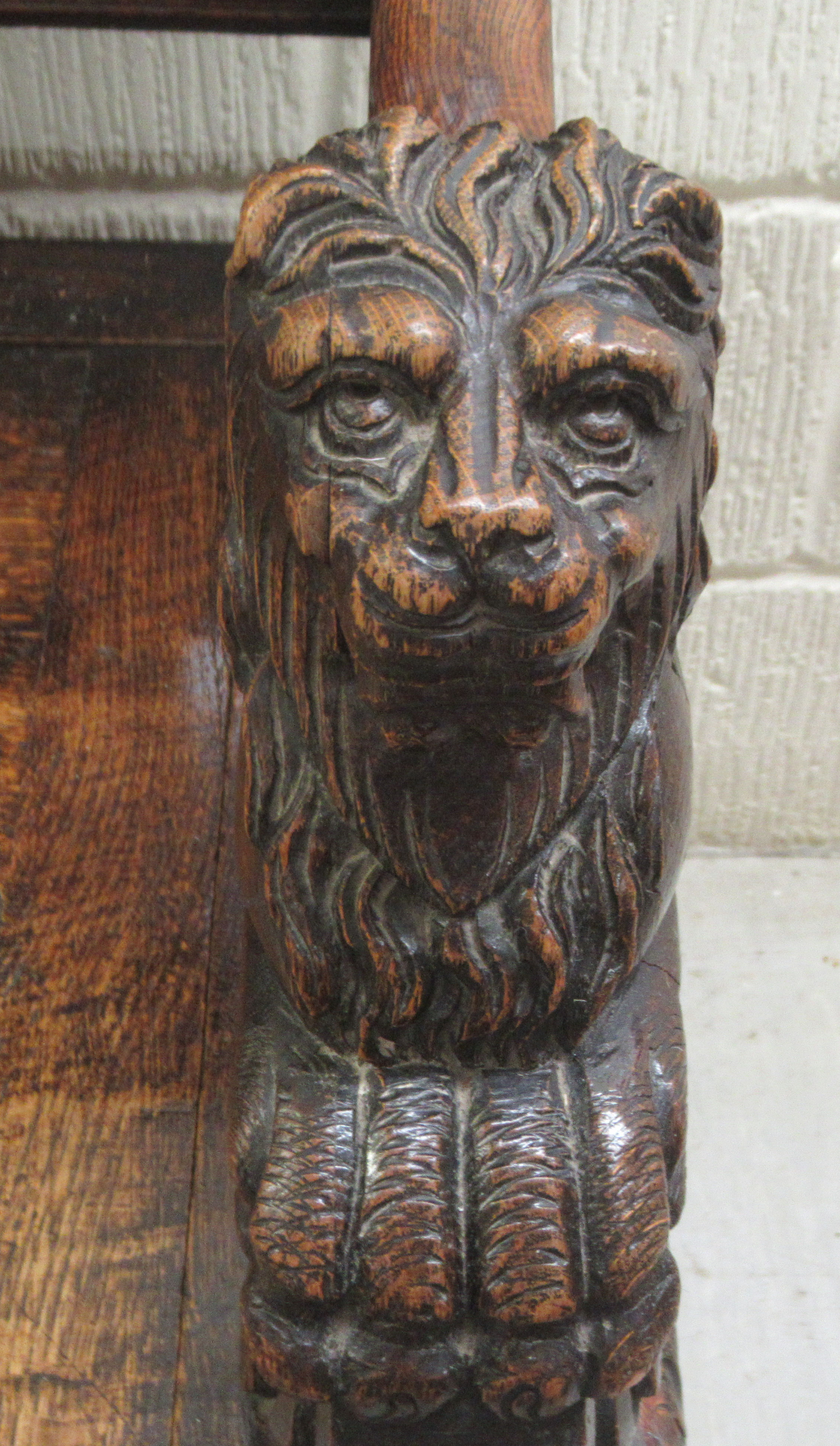 A late Victorian profusely carved oak settle with a high, level, quadruple fielded panelled back and - Image 6 of 7