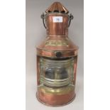 A late 19th/early 20thC copper and brass cased ships stern lantern with a chimney and a clear, rib