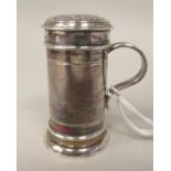 A late Victorian silver sander of cylindrical form with an S-shape handle and decoratively pierced