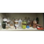 A selection of vintage coloured and clear glass chemists jars, many with identification labels;