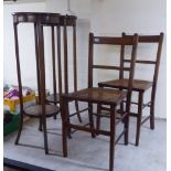 Edwardian furniture, viz. a pair of mahogany plant stands with undershelves, raised on square legs