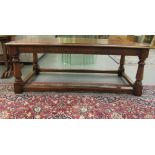 A modern mahogany coffee table with a crossbanded border, raised on ring turned, baluster and