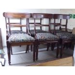 A set of six late Regency mahogany framed dining chairs with curved bar crests, the later tapestry