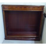 An Edwardian style mahogany and marquetry dwarf bookcase with height adjustable shelves, on a plinth