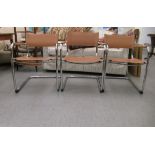 A set of three modern open arm office reception chairs with sprung, tubular stainless steel framed