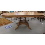 A modern light oak dining table of traditional 19thC design, raised on four uniformly spaced