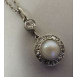 A Victorian gold coloured and white metal pearl and diamond set pendant, on a fine neckchain