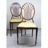 A pair of Edwardian string inlaid walnut framed side chairs with decoratively pierced oval backs,