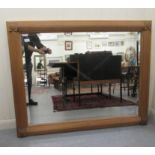 A 19thC style bevelled mirror, set in a reed and rosette carved, bleached mahogany frame  36" x 49"