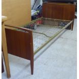 A 1970s teak framed single bed, the headboard, on a sprung base  35"w