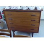 A 1970s teak four drawer dressing chest, raised on tapered legs  41"h  45"w