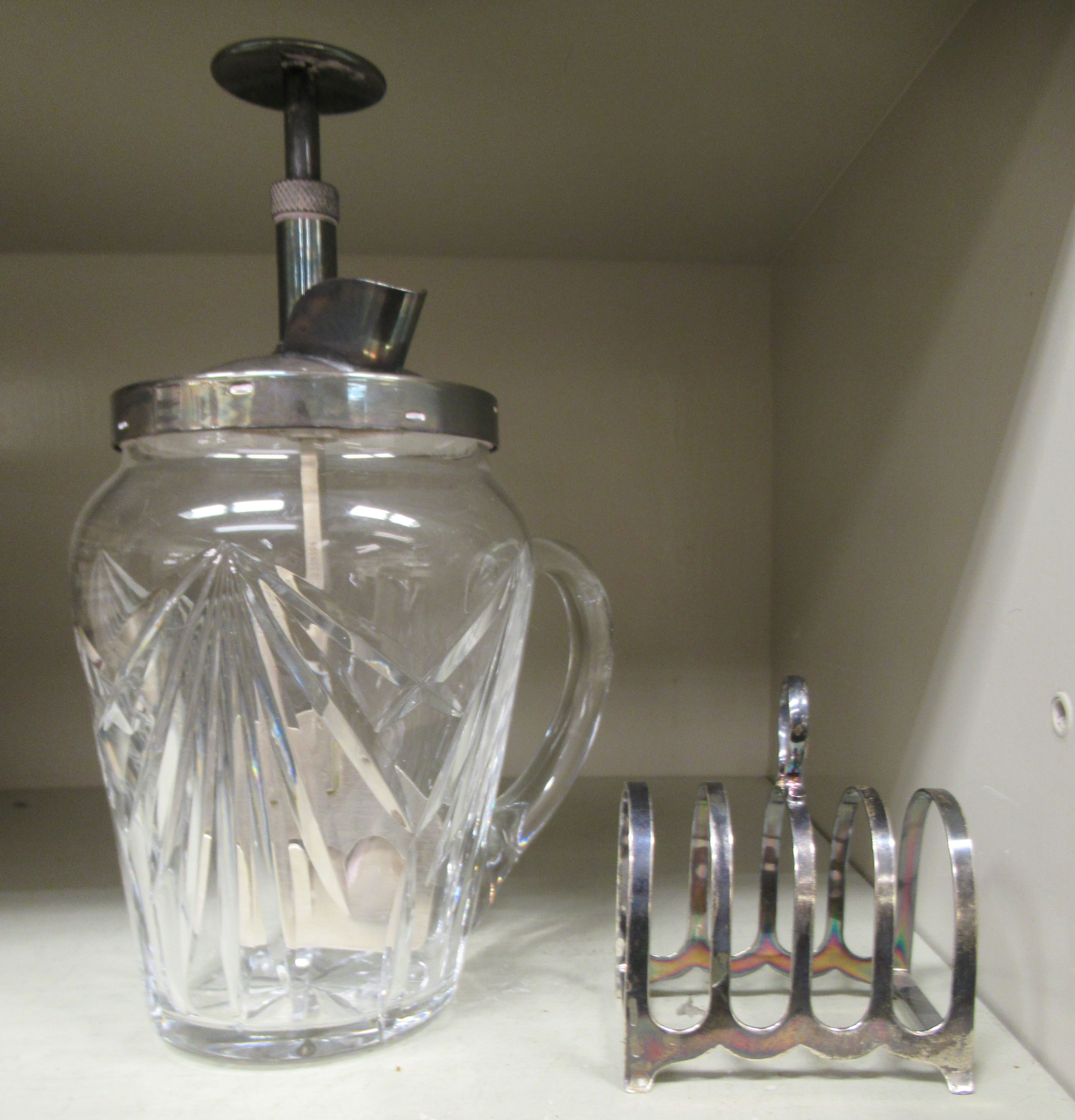 A silver four division toastrack  Sheffield 1943; and an Art Deco slice cut glass cocktail mixer