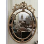 A 19thC style oval, segmented mirror, set in a bead carved and scrolled gilt frame  47" x 33"