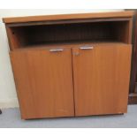 A 1970s/1980s teak finished cabinet, comprising an open shelf, over a pair of lockable doors  29"