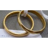 Two 22ct gold wedding rings, one with facetted ornament