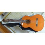 A Yamaha six string acoustic guitar, model No. G.65A with a carrying case